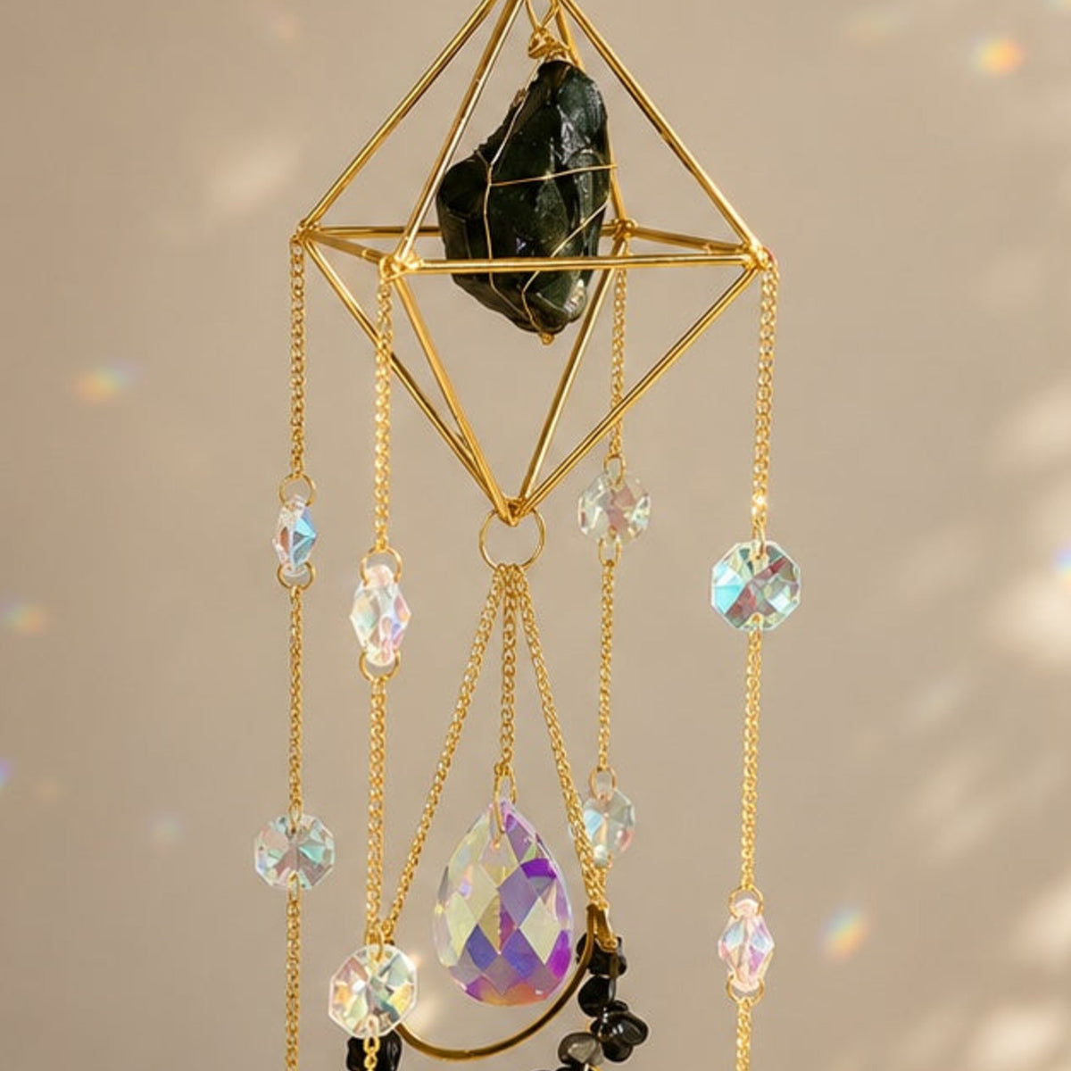 Close-up detail of Celestial Obsidian Sun Catcher crystal and hanging prisms