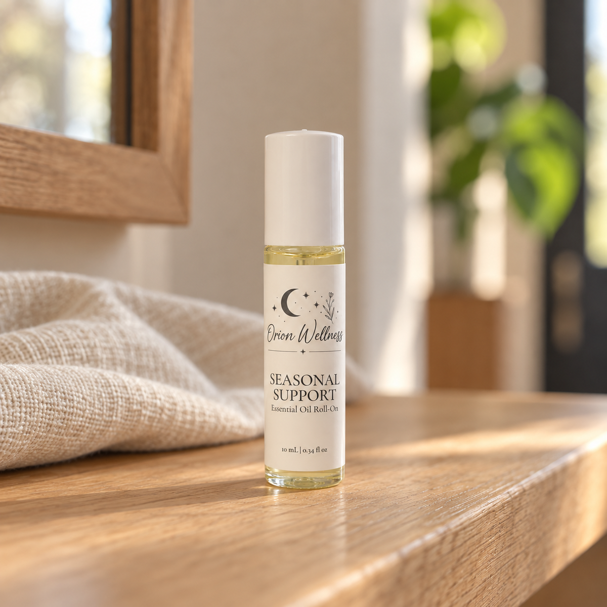 Orion Wellness Seasonal Support 10 mL roll-on in a warm natural home setting