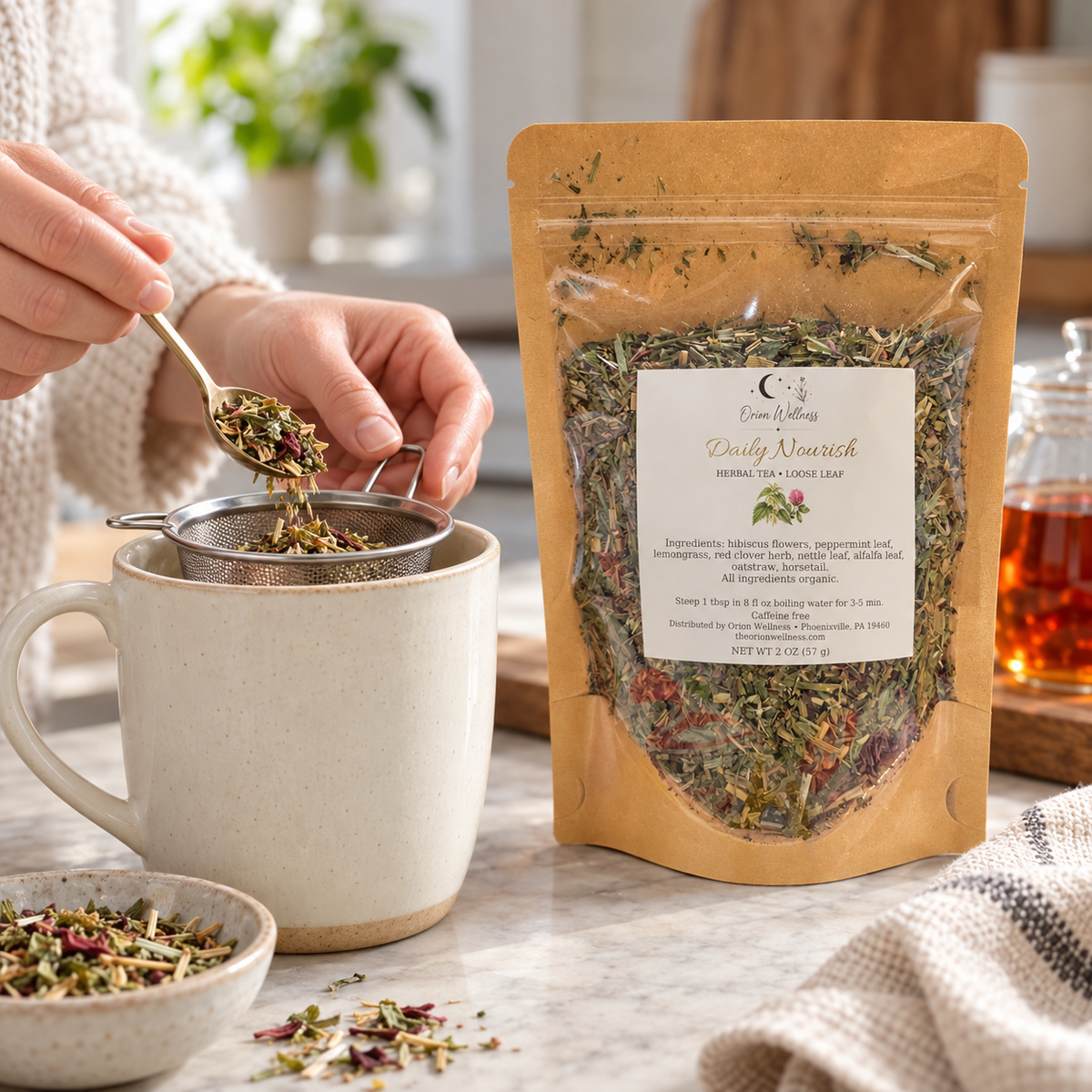 Orion Wellness daily nourish loose leaf tea, being prepared with a tea infuser