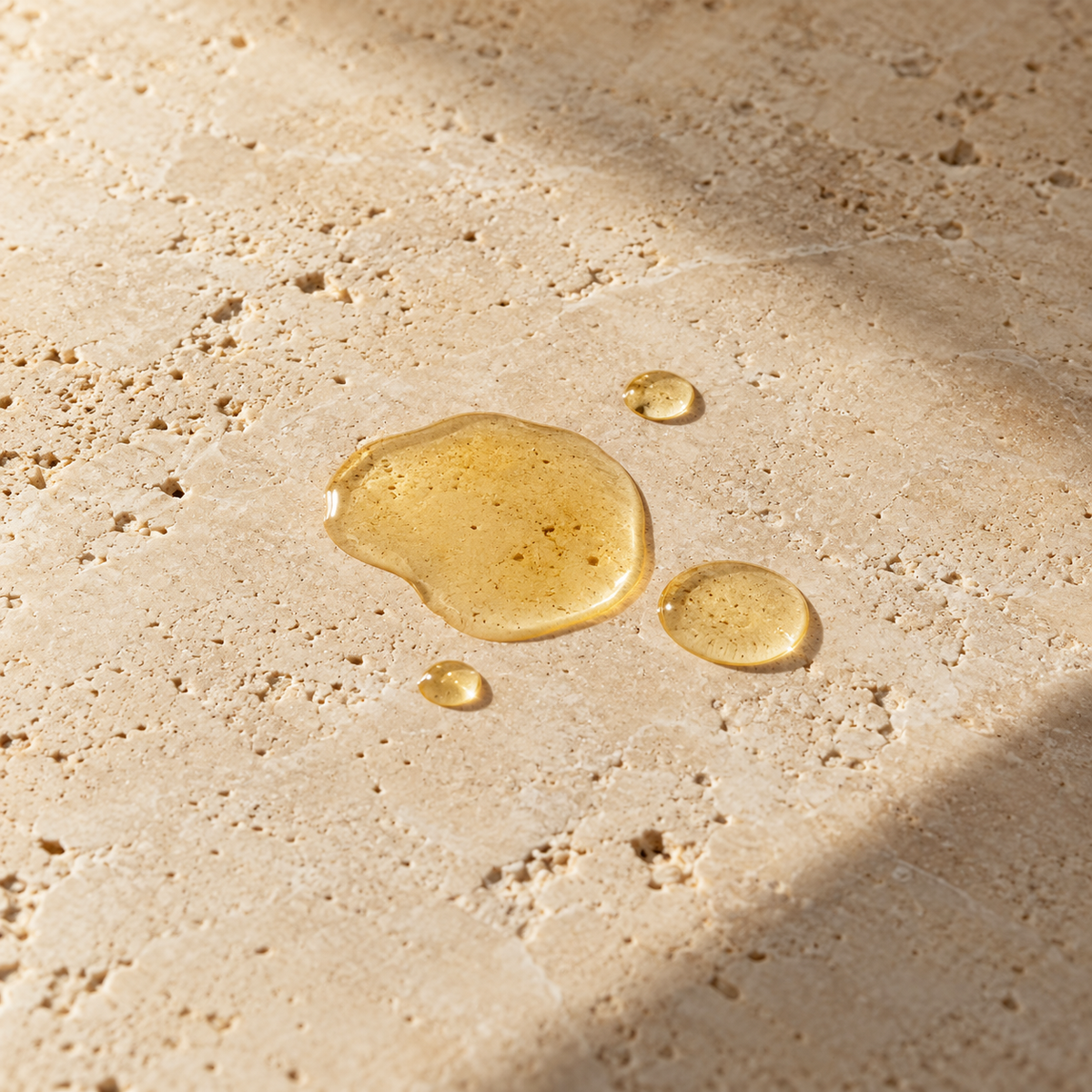 Styled hair-oil texture illustration on warm stone