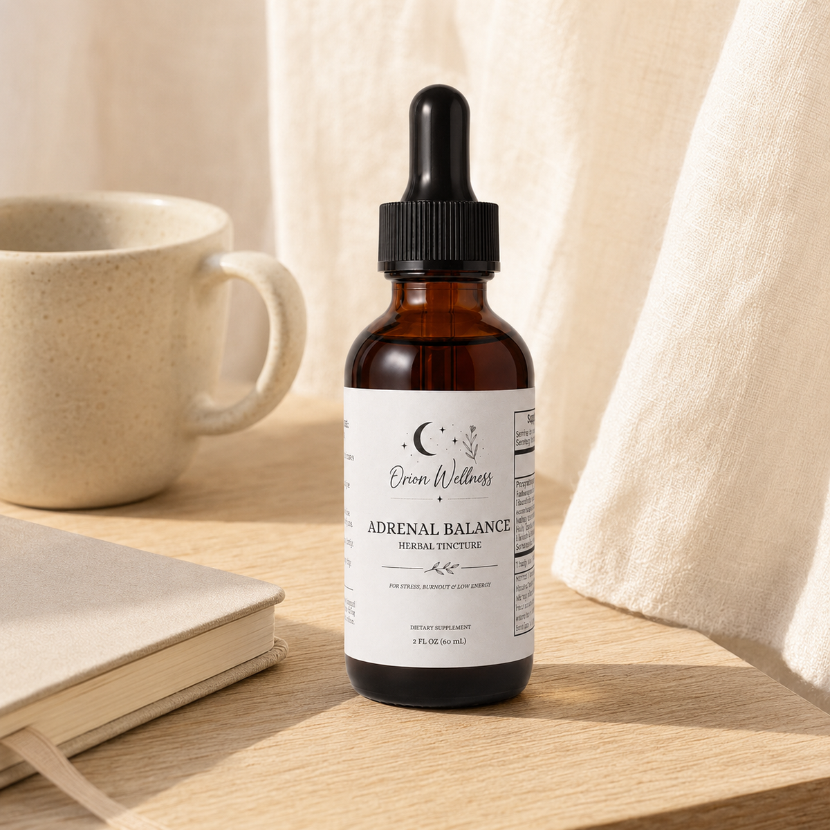 Orion Wellness Adrenal Balance tincture on a sunlit oak desk with a neutral journal, ceramic mug, and linen curtain in the background.