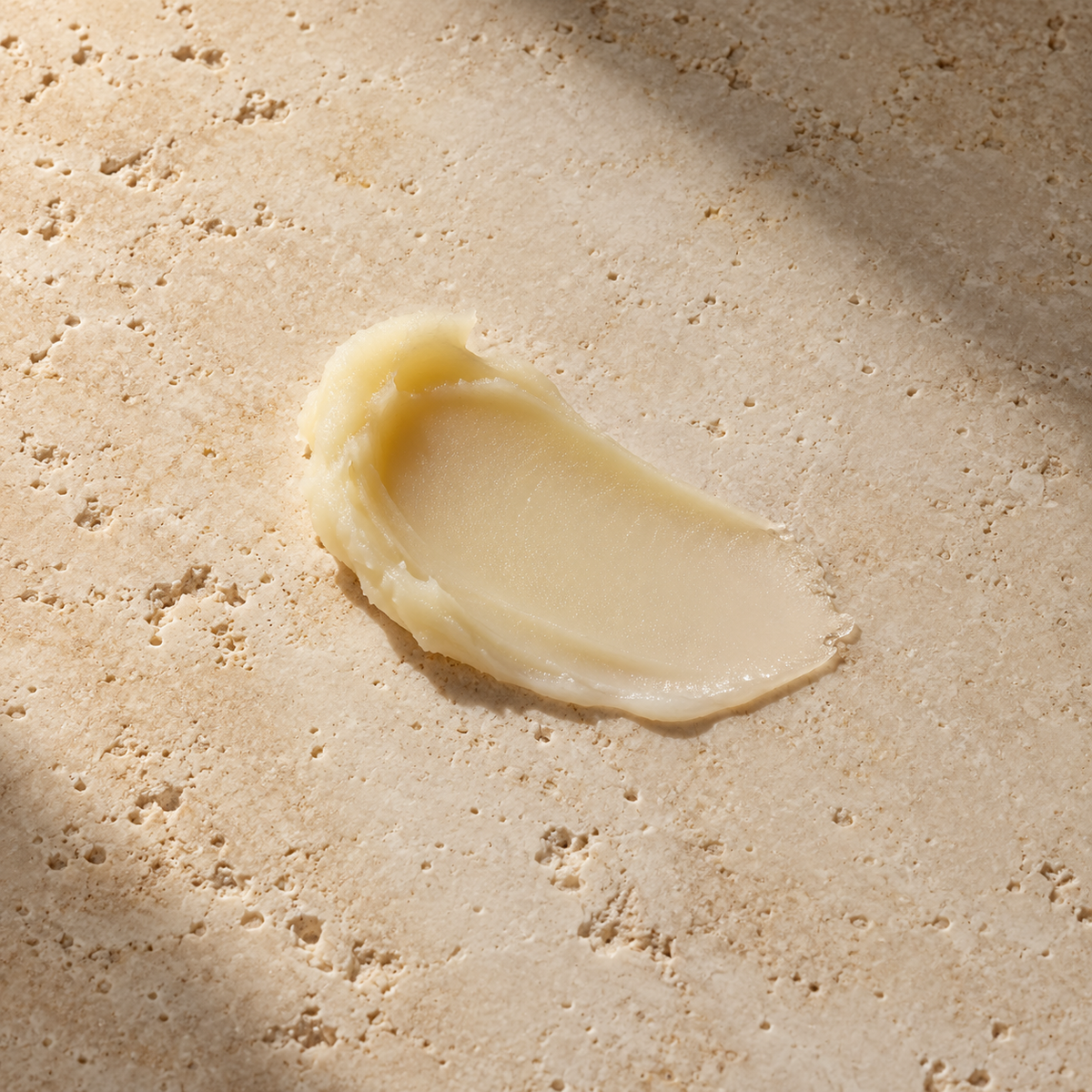 Orion Wellness balm styled texture illustration on warm travertine