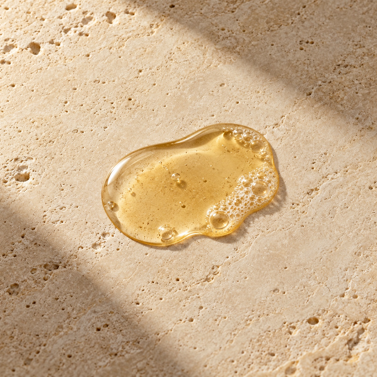 Orion Wellness body wash styled texture illustration on warm travertine