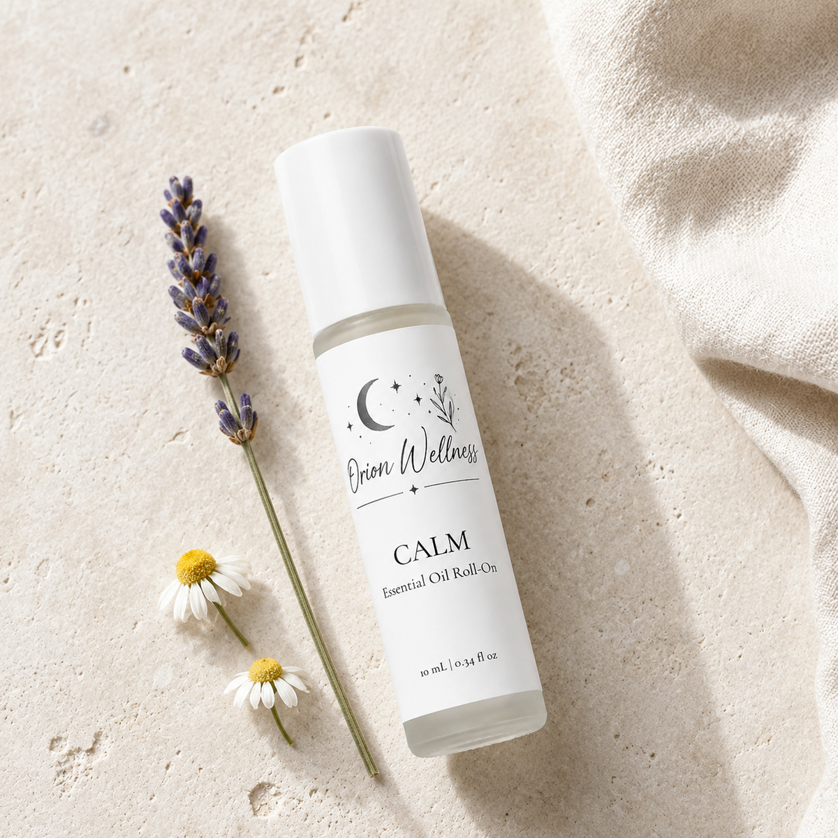 Orion Wellness Calm 10 mL roll-on on pale stone beside lavender, chamomile flowers, and ivory linen.