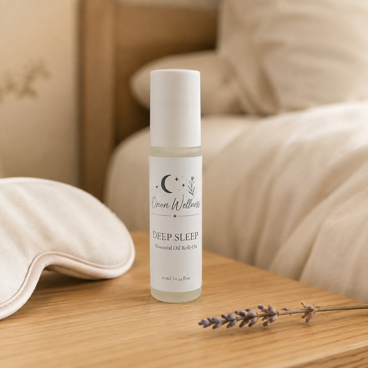 Orion Wellness Deep Sleep roll-on on an oak nightstand beside a cream sleep mask and dried lavender.