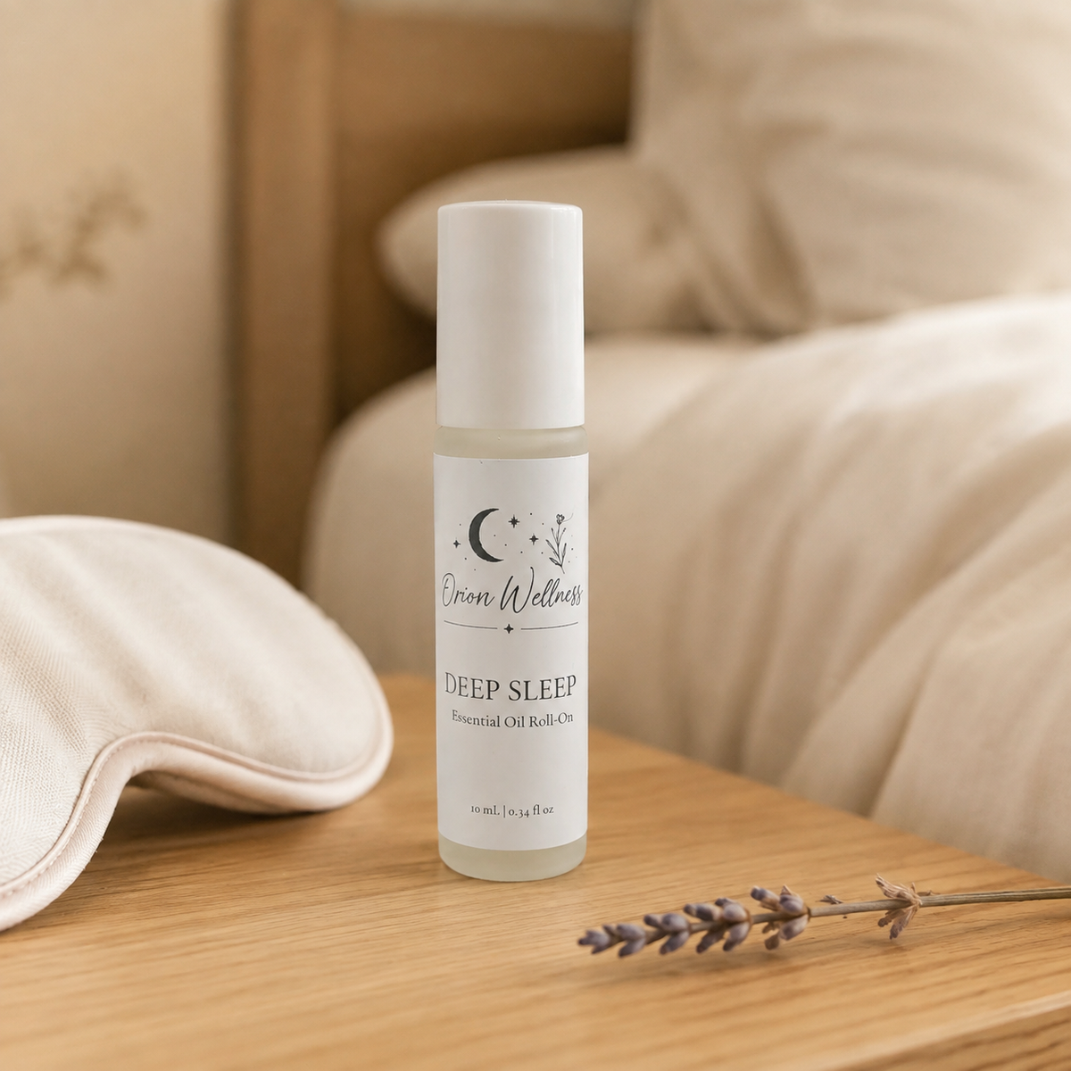 Orion Wellness Deep Sleep roll-on on an oak nightstand beside a cream sleep mask and dried lavender.