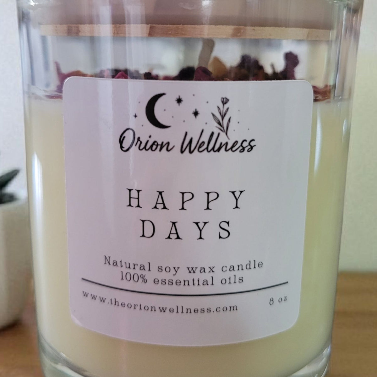 Close-up of Happy Days Candle label by Orion Wellness