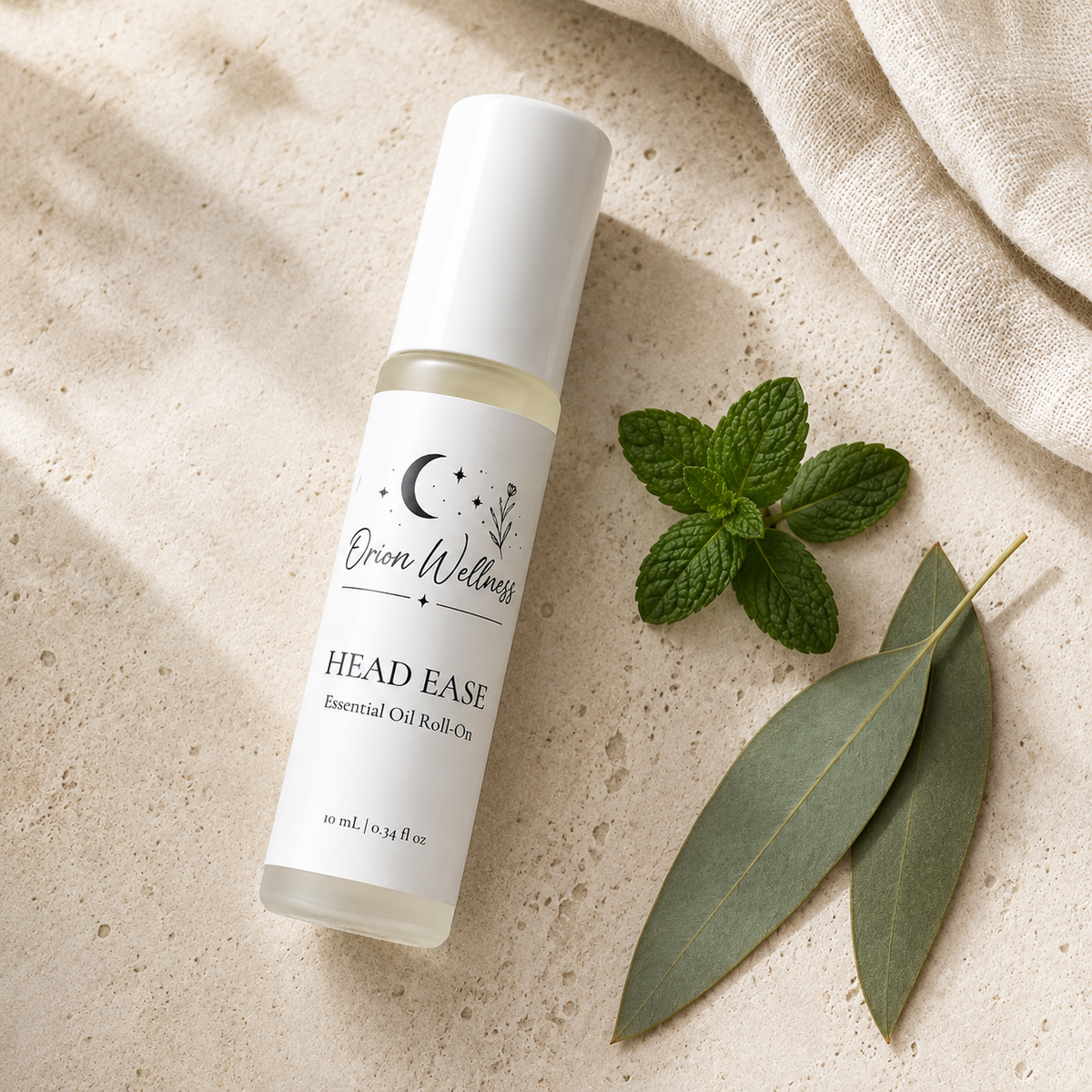 Orion Wellness Head Ease 10 mL roll-on on pale stone beside peppermint, eucalyptus leaves, and ivory linen.
