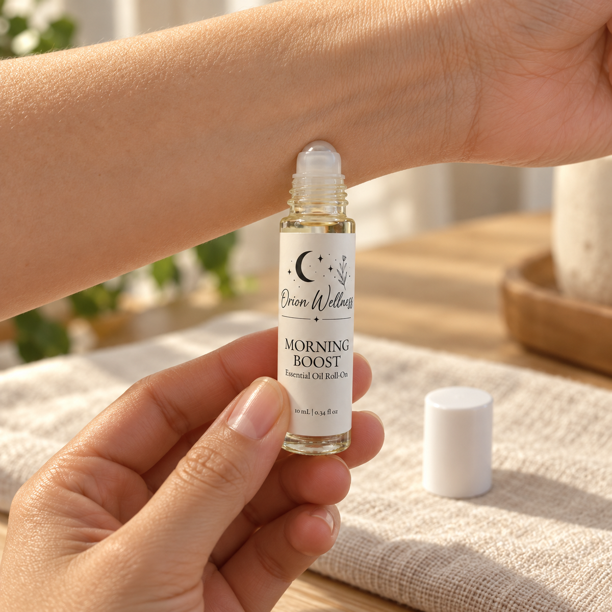 Orion Wellness Morning Boost 10 mL roll-on applied to the inner wrist