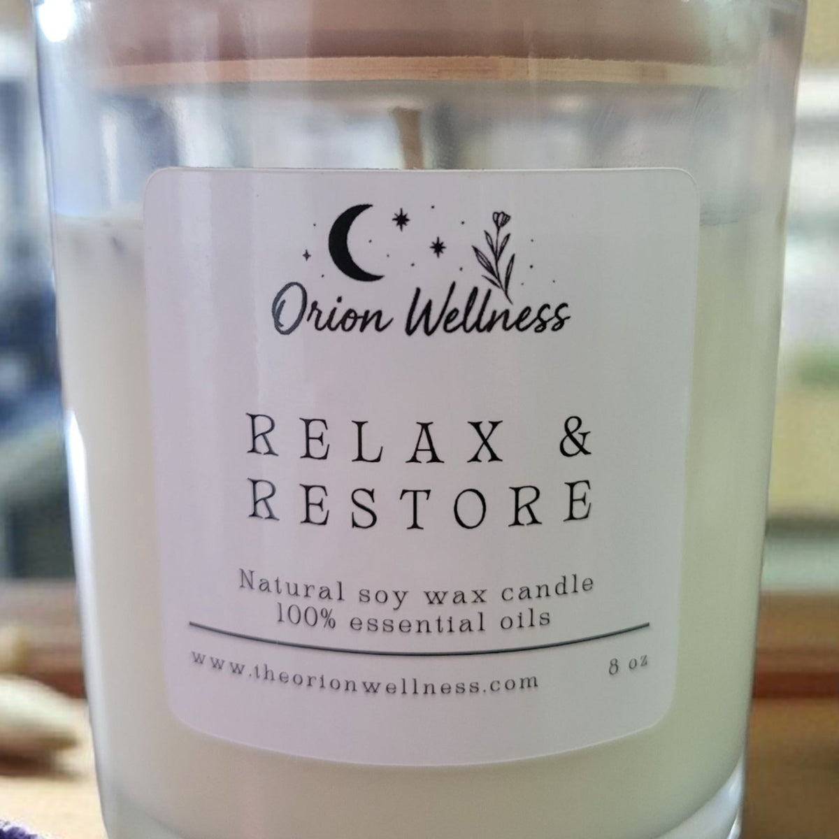 Close-up of Relax & Restore Candle label by Orion Wellness