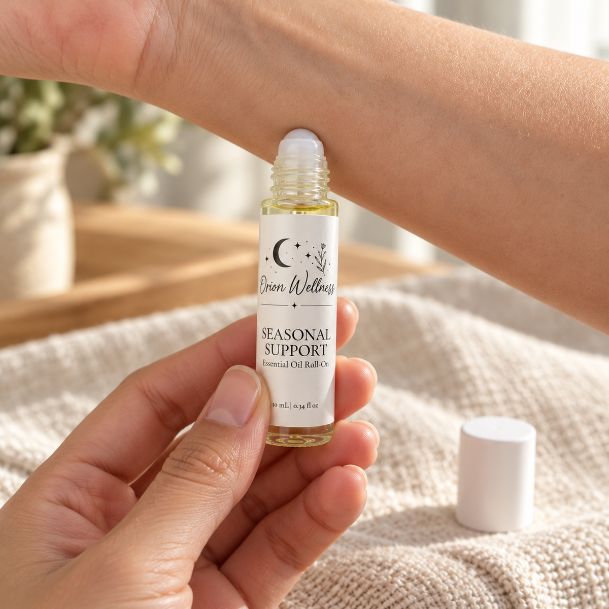Orion Wellness Seasonal Support 10 mL roll-on applied to the inner wrist