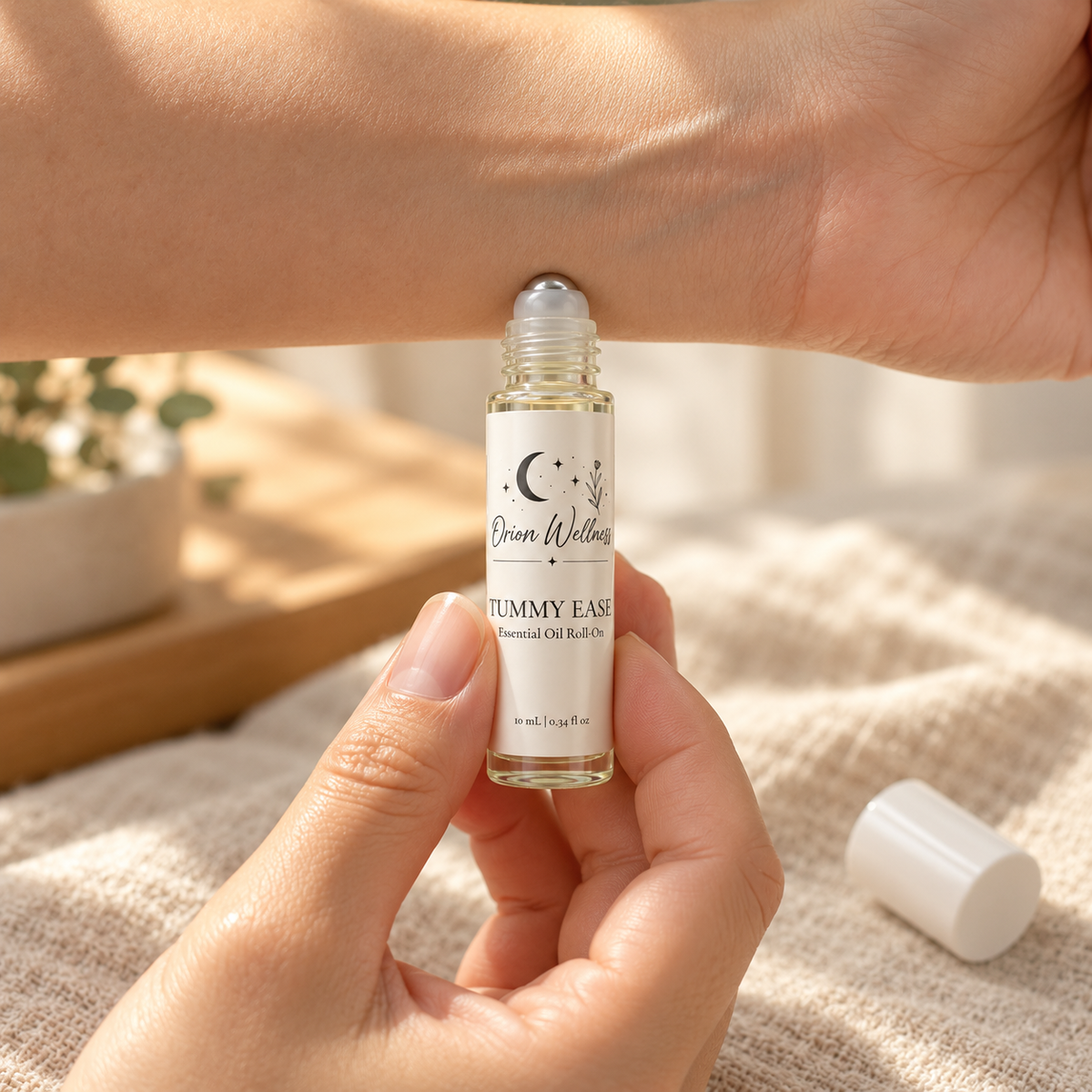 Orion Wellness Tummy Ease 10 mL roll-on applied to the inner wrist